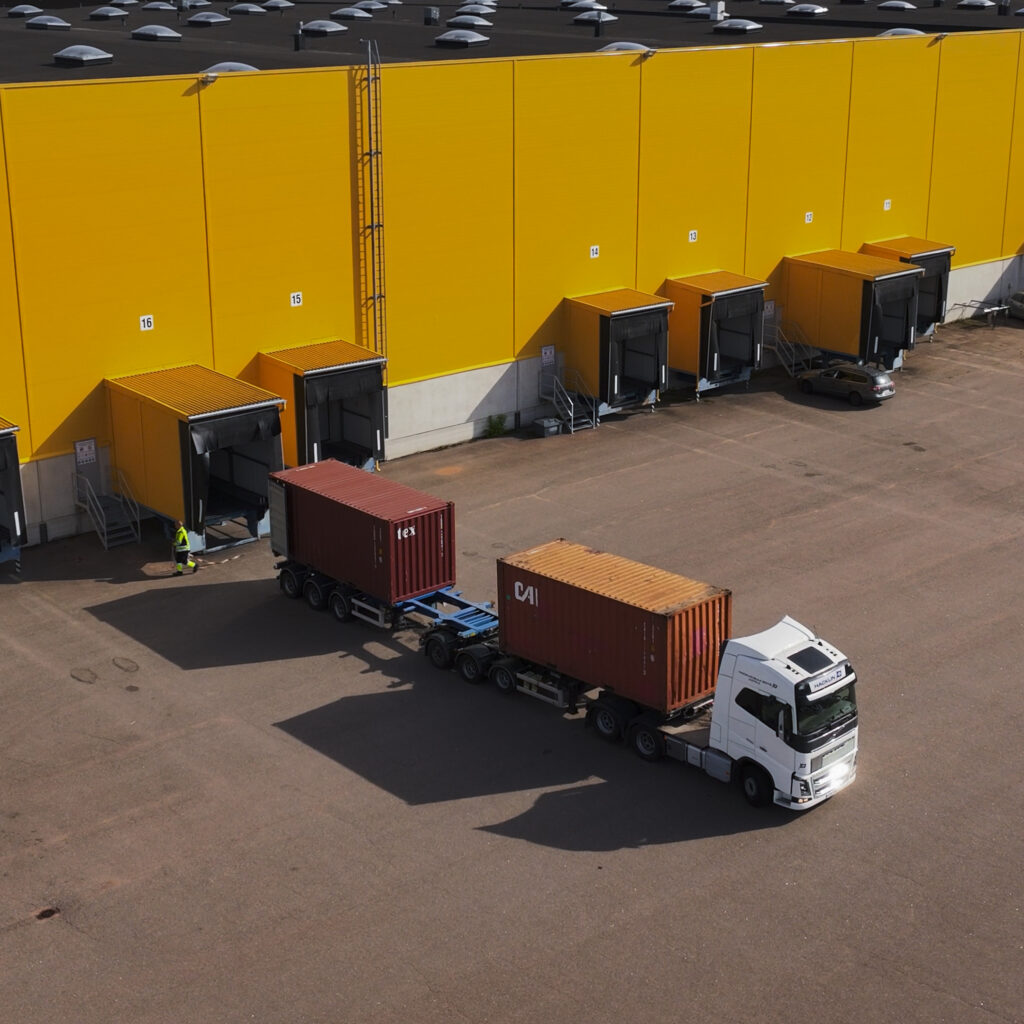 Container transport and warehouse loading operations at Hacklin Hamiko logistics center in HaminaKotka, Finland.