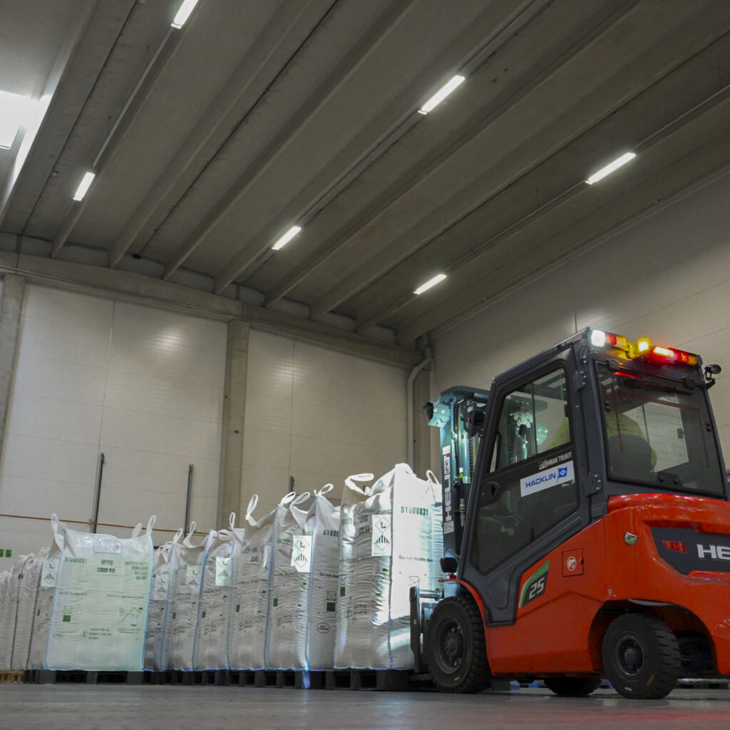 Forklift transporting palletized industrial materials in a warehouse near the Port of HaminaKotka, Finland.